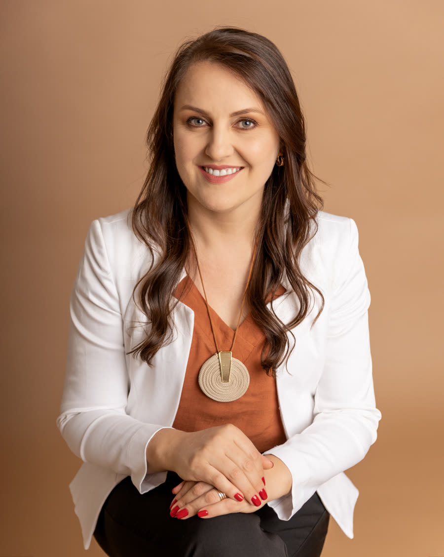 Simoni Perondi, educadora e facilitadora, sentada e sorrindo